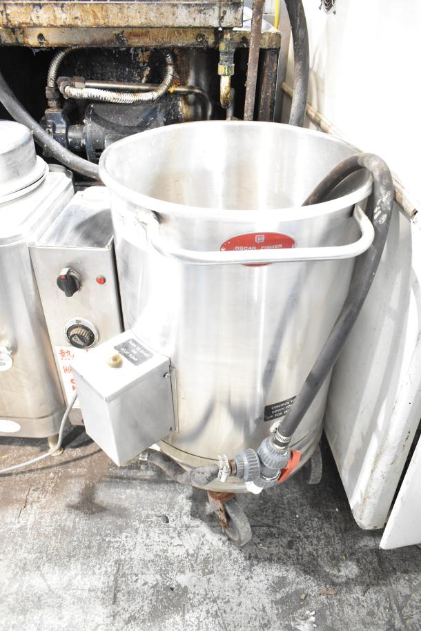 Oscar Fisher stainless steel tank, used condition, with attached hoses and control valve, on wheeled base for mobility.