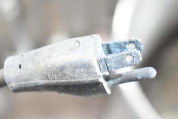 Oscar Fisher stainless steel tank with visible wear, showing close-up of power plug. Ideal for industrial use.