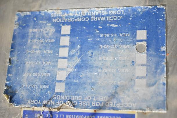 Cecilware Commercial Hot Tea Urn, showing a worn blue label with specifications and manufacturing details.