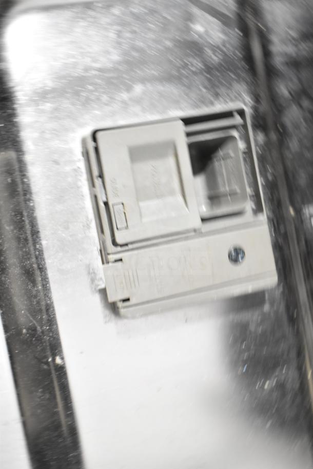 Whirlpool WDT30HAMZ0 undercounter dishwasher detail, silver finish, soap dispenser visible, good condition.