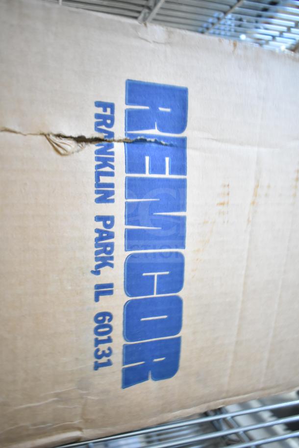 Baxter Mini-K Compressor box, 115V, 1 Phase, label indicating "Remcor, Franklin Park, IL 60131." Box appears slightly worn.