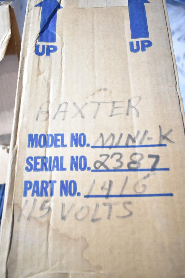 Baxter Mini-K Compressor box with markings: Model No. Mini-K, Serial No. 2387, Part No. 1416, 115 Volts. Box shows signs of wear.