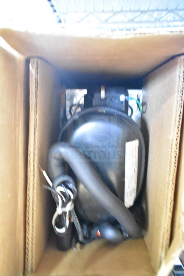 Baxter Mini-K Compressor, 115V, 1 Phase, packed in cardboard. Compact design, good condition, suitable for various applications.