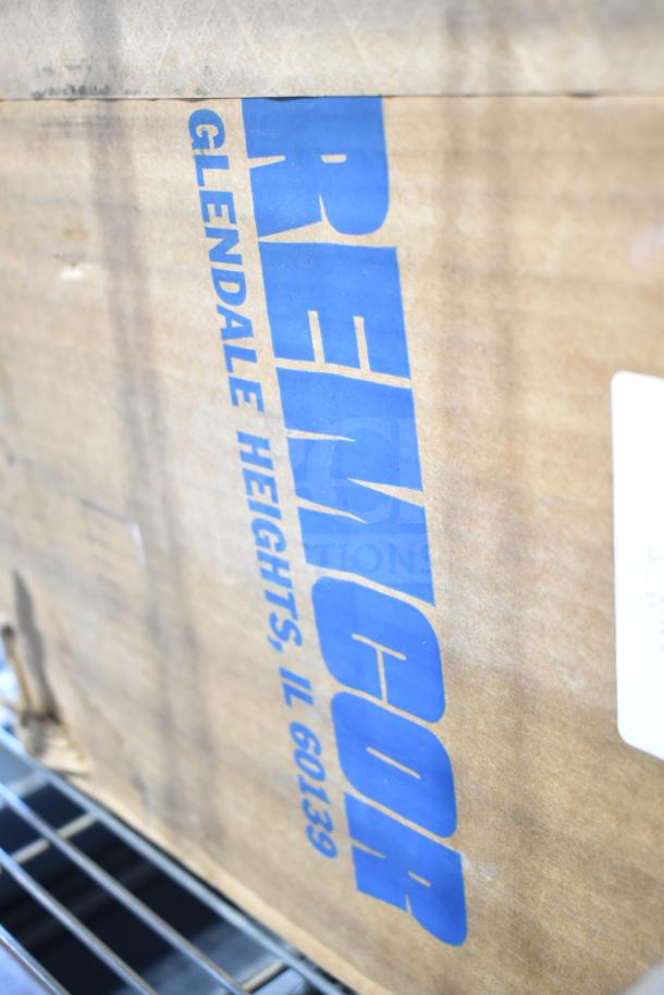 Baxter Mini-K Compressor box, 115 volts, 1 phase. Features Remcor marking, Glendale Heights, IL. Brown cardboard packaging.