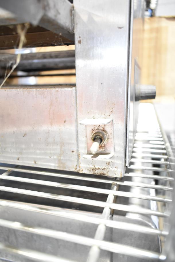 Holman 214HX countertop conveyor oven, visible wear on metal exterior, for parts or repair. 208V, 1 phase.