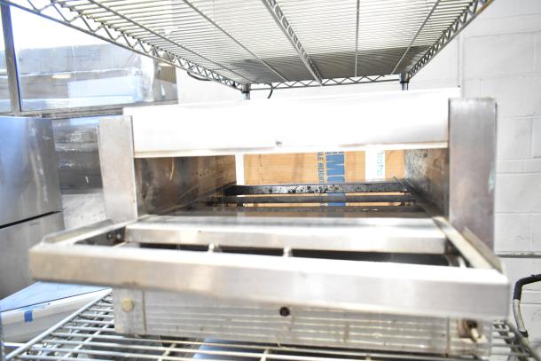 Holman 214HX countertop conveyor oven, used condition, 208V, 1 phase. Stainless steel, interior view showing conveyor.