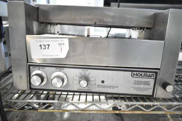 Holman countertop electric conveyor oven, stainless steel, adjustable heat settings, used condition, auction tag visible.