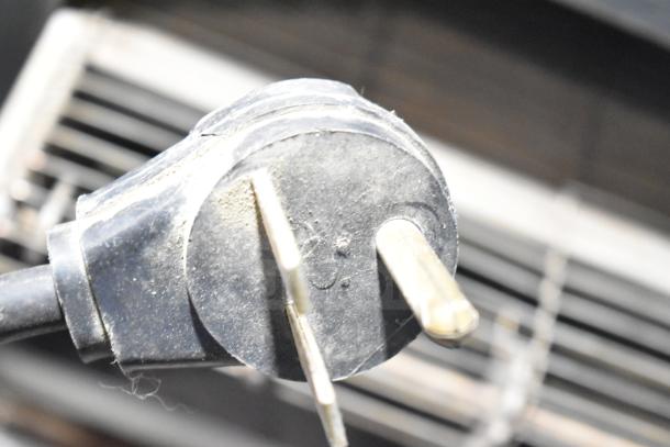 Holman Countertop Electric Conveyor Oven plug showing wear, suitable for efficient cooking needs.