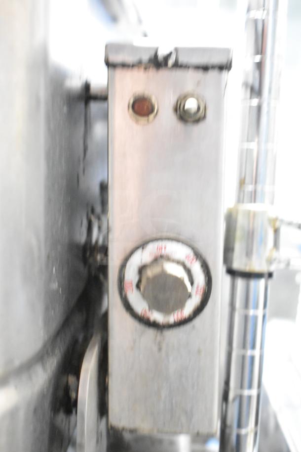 Groen commercial braising pan control knobs with temperature dial, highlighting stainless steel finish and slight wear.