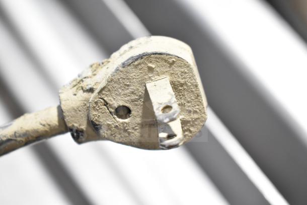 Close-up of a worn power plug from a Juice Tree 106 Commercial Citrus Juicer, 115 volts, 1 phase.