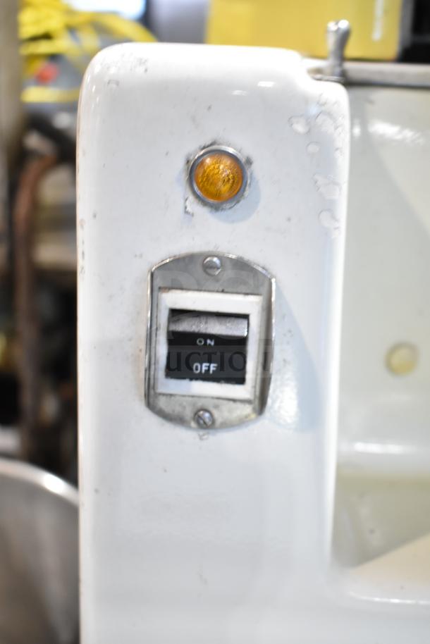 Juice Tree 105 commercial citrus juicer, floor style. Features on/off switch, visible wear. Model 105, 115V, 1 phase.