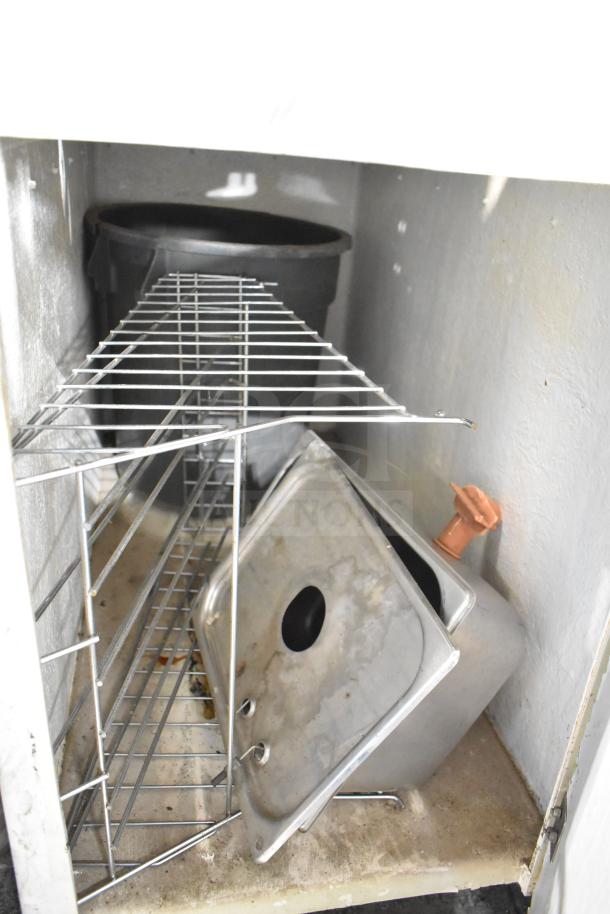 Juice Tree 105 commercial citrus juicer interior view. Includes metal components and a black container. Condition appears used.