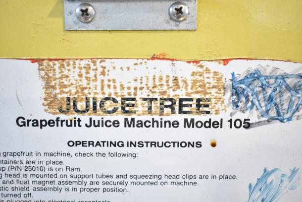 Juice Tree 105 Citrus Juicer label, showing brand and model with visible wear and operating instructions.