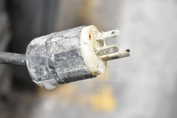 Dirty and worn electrical plug of the Hatco GRSDS/H-36D heated display shelf, showing damage.