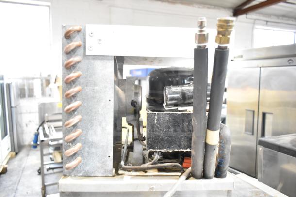 Larco Electric Water Cooler, 115 Volts, 1 Phase, in fair condition, visible coils and compressor unit.