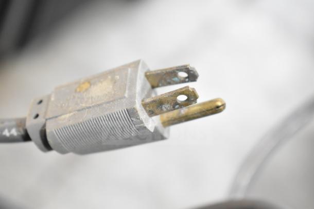 Close-up of a power plug for a Larco Electric Water Cooler, showing signs of wear. 115 volts, 1 phase.