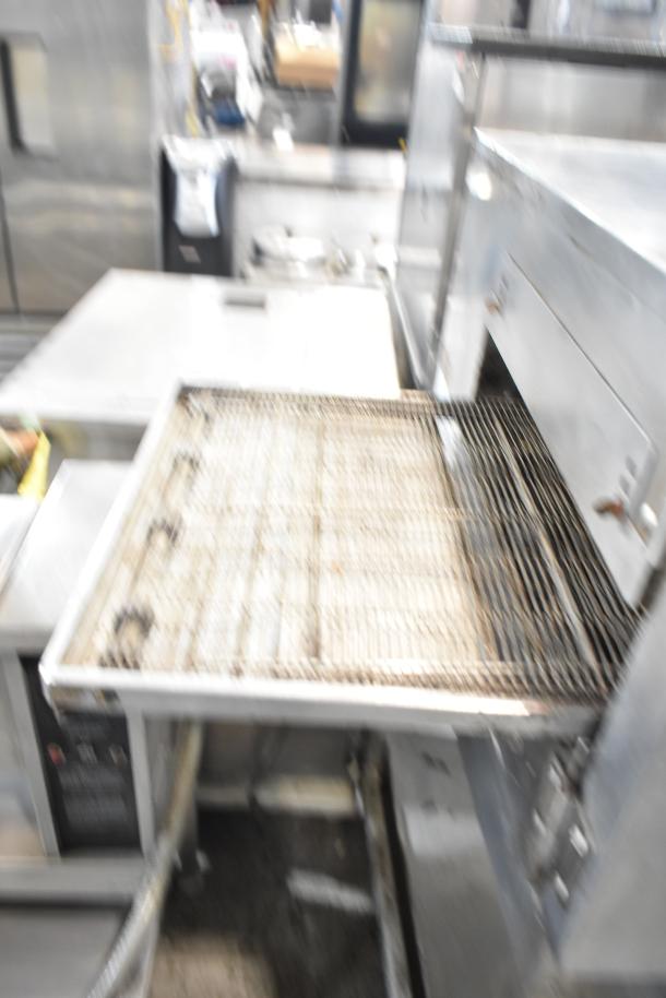 Lincoln Impinger commercial conveyor pizza oven on equipment stand, stainless steel, used condition, ideal for high-volume pizzerias.
