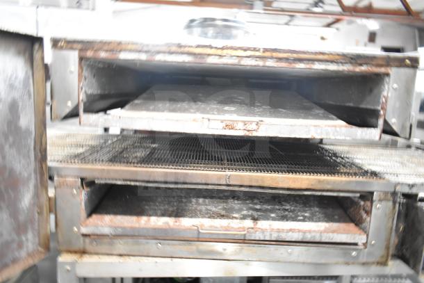 Lincoln Impinger commercial conveyor pizza oven on equipment stand, visible wear, dual decks, stainless steel construction.