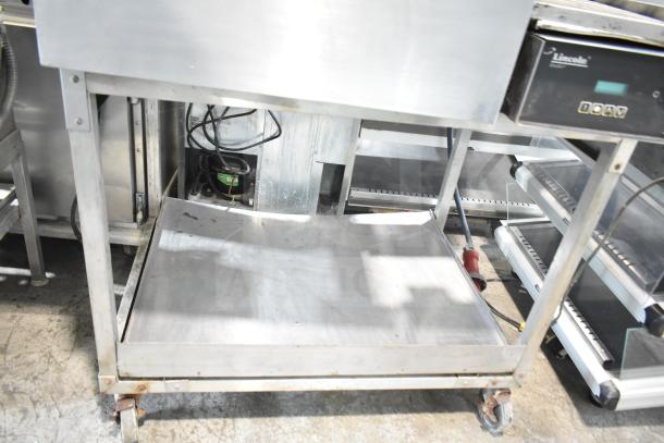 Lincoln Impinger Commercial Conveyor Pizza Oven on equipment stand, stainless steel finish, visible controls and wiring, used condition.
