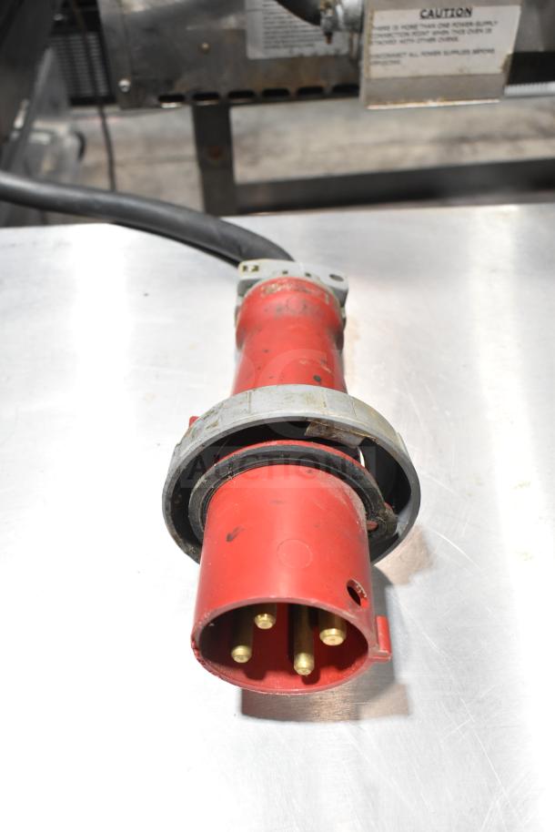 Red power connector for a Lincoln Impinger Commercial Conveyor Pizza Oven, showing four prongs and a robust design.