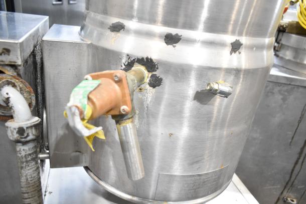 Crown Steam EC-10TW tilting kettle, 10-gallon capacity, showing wear and paint chips on exterior. Model plate visible.