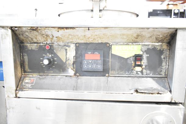 BKI FKM-F commercial electric pressure fryer on casters, 208/230V, 3-phase. Worn exterior with visible control panel and labels.
