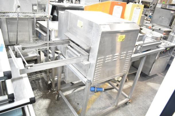 Belshaw TG50 Thermoglazing Station, stainless steel, on commercial casters, 208V, 1 phase, used condition, visible caution labels.