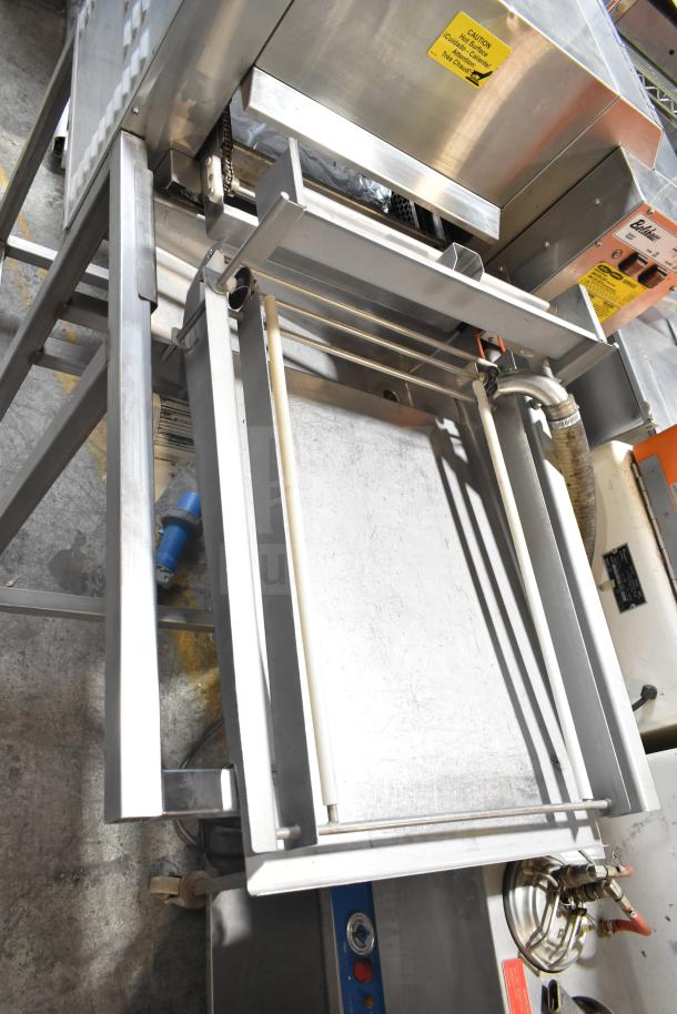 Belshaw TG50 commercial thermoglazing station, stainless steel, on casters, 208V, 1 phase, with safety labels visible.