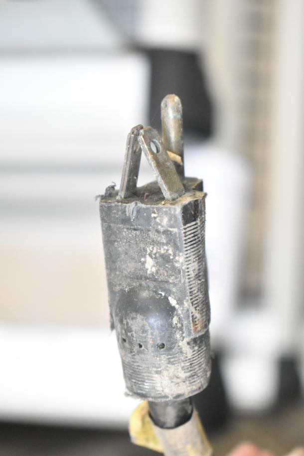 Old, worn plug with visible wear and dirt, part of a Bunn G9 Commercial Coffee Bean Grinder, 120 Volts, 1 Phase.