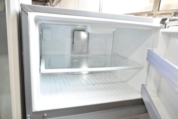 Whirlpool WRT511SZDM00 reach-in cooler with freezer. Interior view showing shelves. Model in good condition, 115V, 1 Phase.