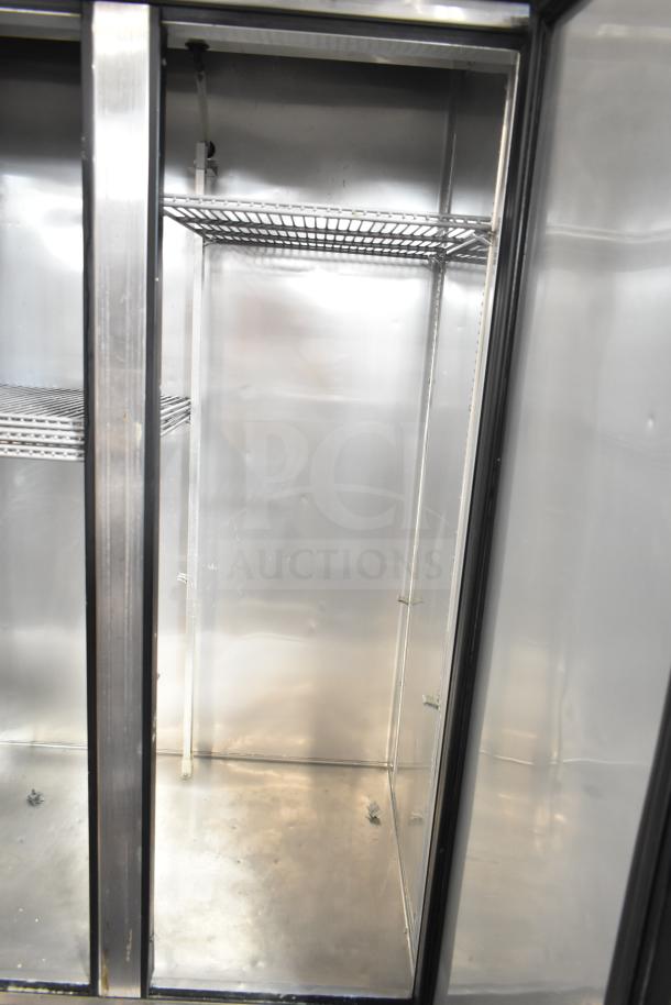 2016 True T-35 commercial 2-door reach-in cooler, 115 volts, 1 phase; clean interior with metal shelves visible.