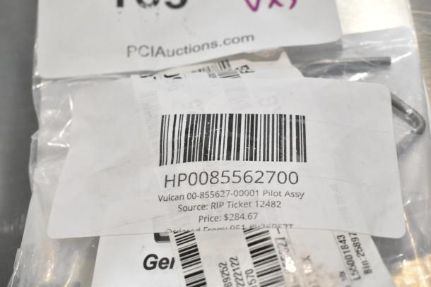 3 new scratch and dent items including Vulcan Pilot Assy HP0085562700, visible barcode and labels, auction package.