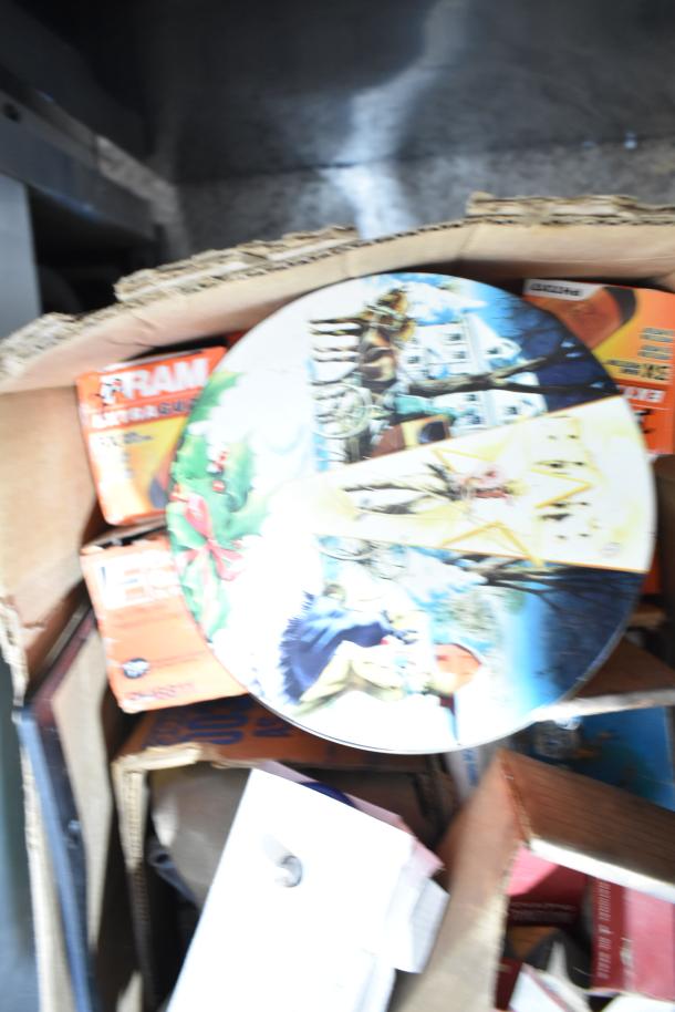 Lot of various items in a box, including Fram PH4967 Extra Guard filter and Napa thermostat. Visible wear on box.