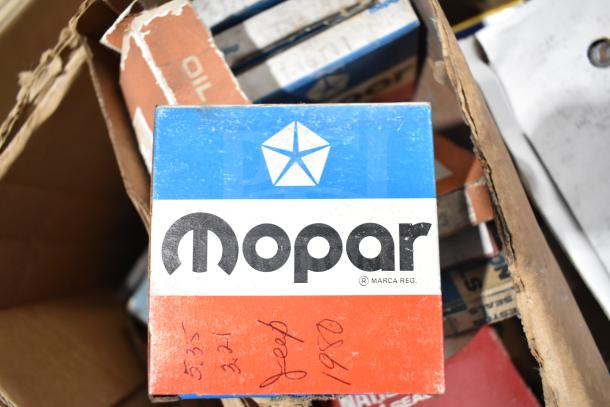 Lot of automotive items including a Mopar box with a pentastar logo, marked 'Jeep 1950', FRAM PH4967 filter, and Napa thermostat.