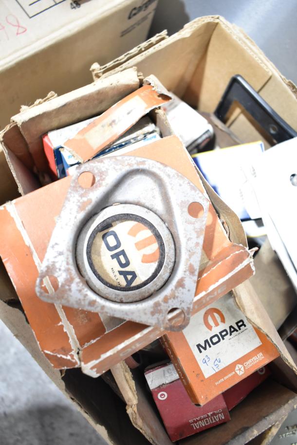 Lot of automotive parts including Mopar, Fram PH4967 oil filter, Napa thermostat, in used condition, assorted boxes.