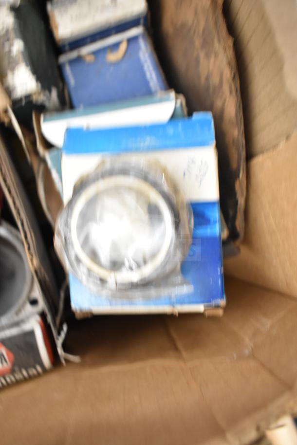 Lot of various car parts including Fram PH4967 Extra Guard and Napa Thermostat in packaging, some wear visible.