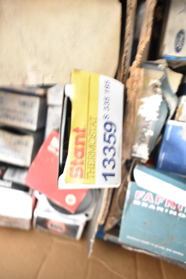 Lot of various automotive items, including a Stant Thermostat 13359, visible wear on packaging.