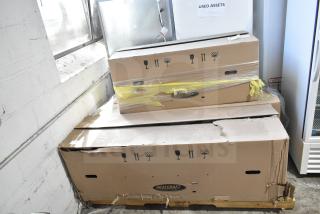 Three Heatcraft boxes stacked, containing new Bohn BEL0650AG6AMAD2107 and BEL0130CC6EEAYF859 evaporator fans, with minor damage.