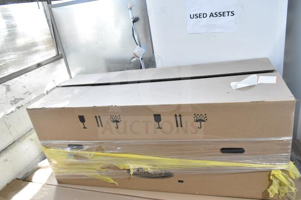 Cardboard box labeled "USED ASSETS" containing three new Bohn evaporator fan units, model BEL0130CC6EEAYF859, scratch and dent condition.