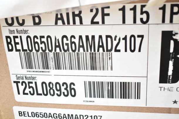 Barcoded label showing item number BEL0650AG6AMAD2107 and serial T25L08936 on a scratch and dent auction package.