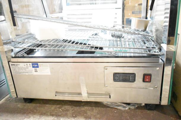 Brand new ServIt 423HDM26SA 26" heated display case with sliding doors, 3 shelves, 120V, 1 Phase, slight scratches.