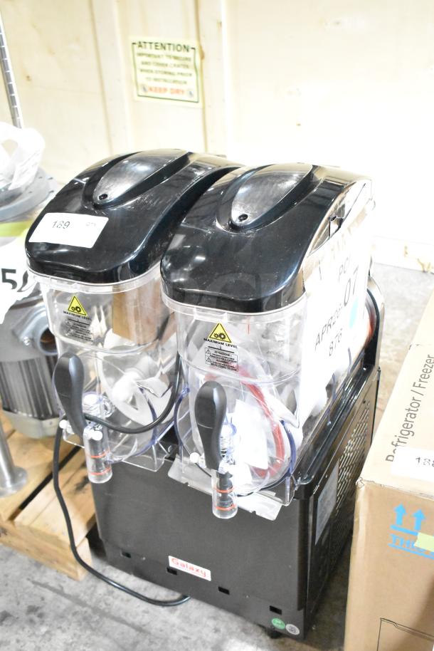 Brand new Galaxy 177GSM2 Granita machine, double 3-gallon, 120V, with visible scratch and dent. Black lid, clear containers.