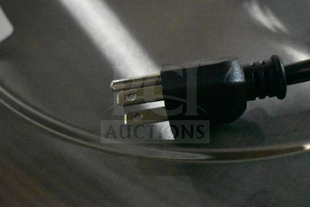 Close-up of Avantco 177RWB60W rice warmer power cord plug resting on metal surface, 120V, scratch and dent condition.