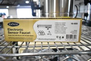 Box of Krowne 16-655 Royal Series Faucet, wall mount, single hole, infrared sensor operated, brand new, scratch and dent.