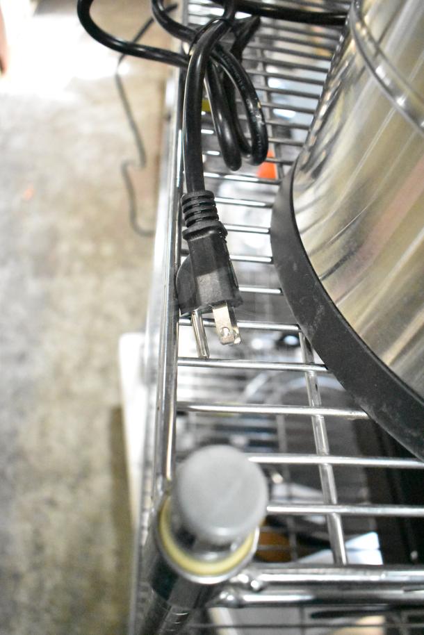 Avantco 177CU100ETL stainless steel coffee urn with power cord, seated on a metal rack. Brand new condition.