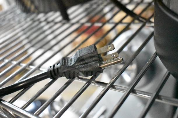 Alt text: "Avantco 177WB29L water boiler power cord on metal rack, indicating 120V electrical compatibility."