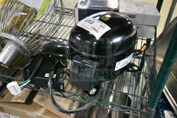 Brand new Embraco NT6215Z compressor, 115V, 1 phase, with minor scratches. Tag indicates "213" and "BRAND NEW".