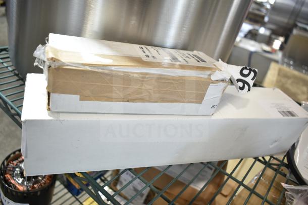 New Vulcan Hart thermostat boxes, models 00-419999-00001 and 00-719298, on a metal shelf. Auction tag visible.