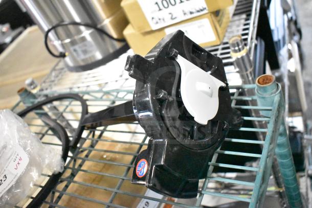 Black and white Continental Refrigerator faucet lock on a metal shelf, brand new condition with included components.