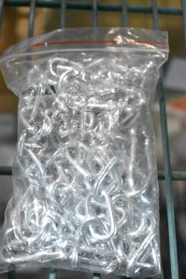 Clear plastic bag with metal hooks, part of 4-brand new scratch and dent items, includes Continental and Cleveland parts.